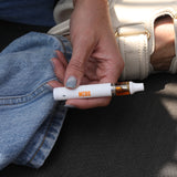 Tropical Citrus Pen - Sativa Inspired Blend - THCA CBD and THCV - Woman Holding Discreet Pen in Hand - MCRO Edibles in the U.S.